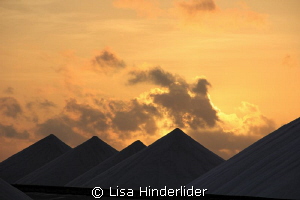 Morning sun rising behind the salt piles- Bonaire by Lisa Hinderlider 